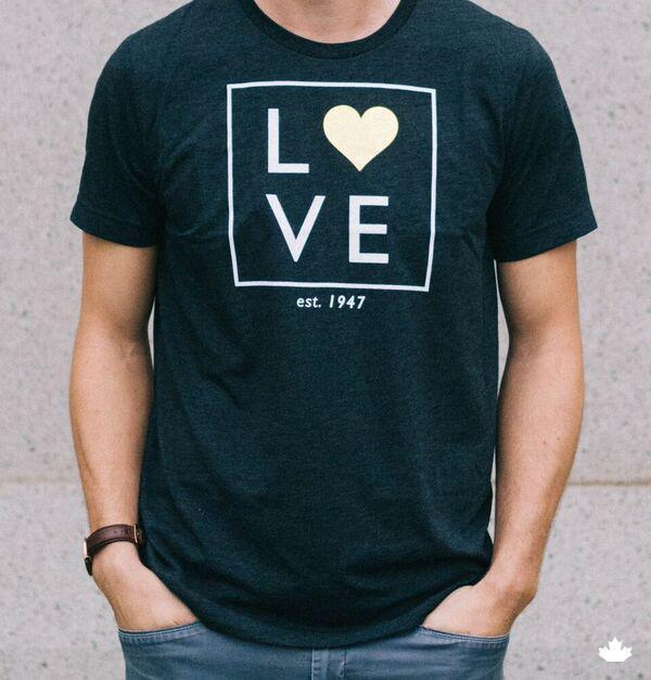 A man wearing the World Vision Heart of Gold dark grey t-shirt.