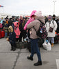 A woman holding a baby in front of a crowd formed by refugee families in the Ukraine. Photo by DANIEL MIHAILESCU/AFP via Getty Images